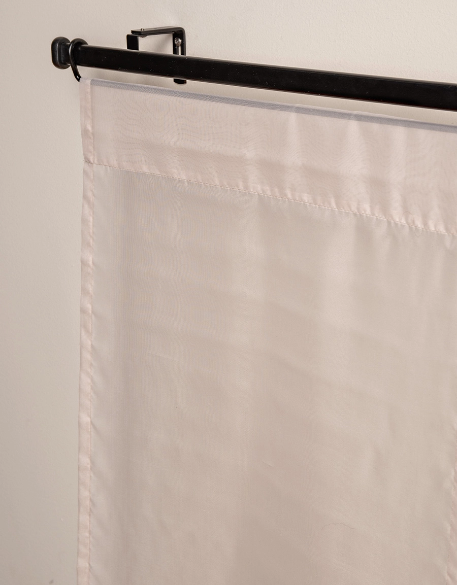 Närbild på beige transparent panelgardin