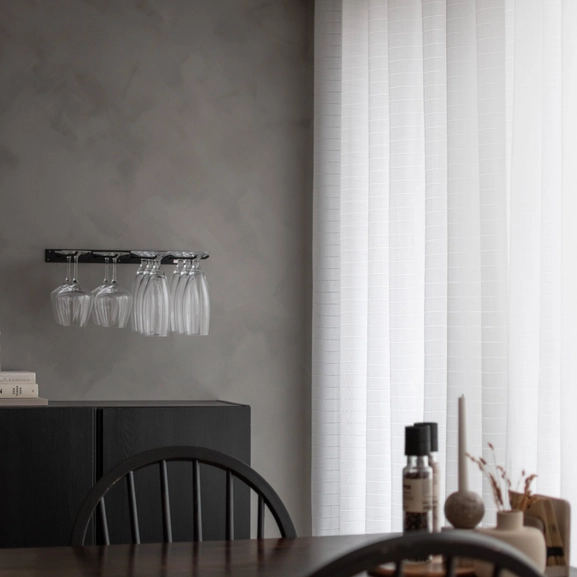 Made-to-measure Minna curtain with a die-cut check pattern in the dining room.