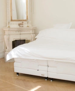 Vit säng i klassisk miljö med svarta sängben