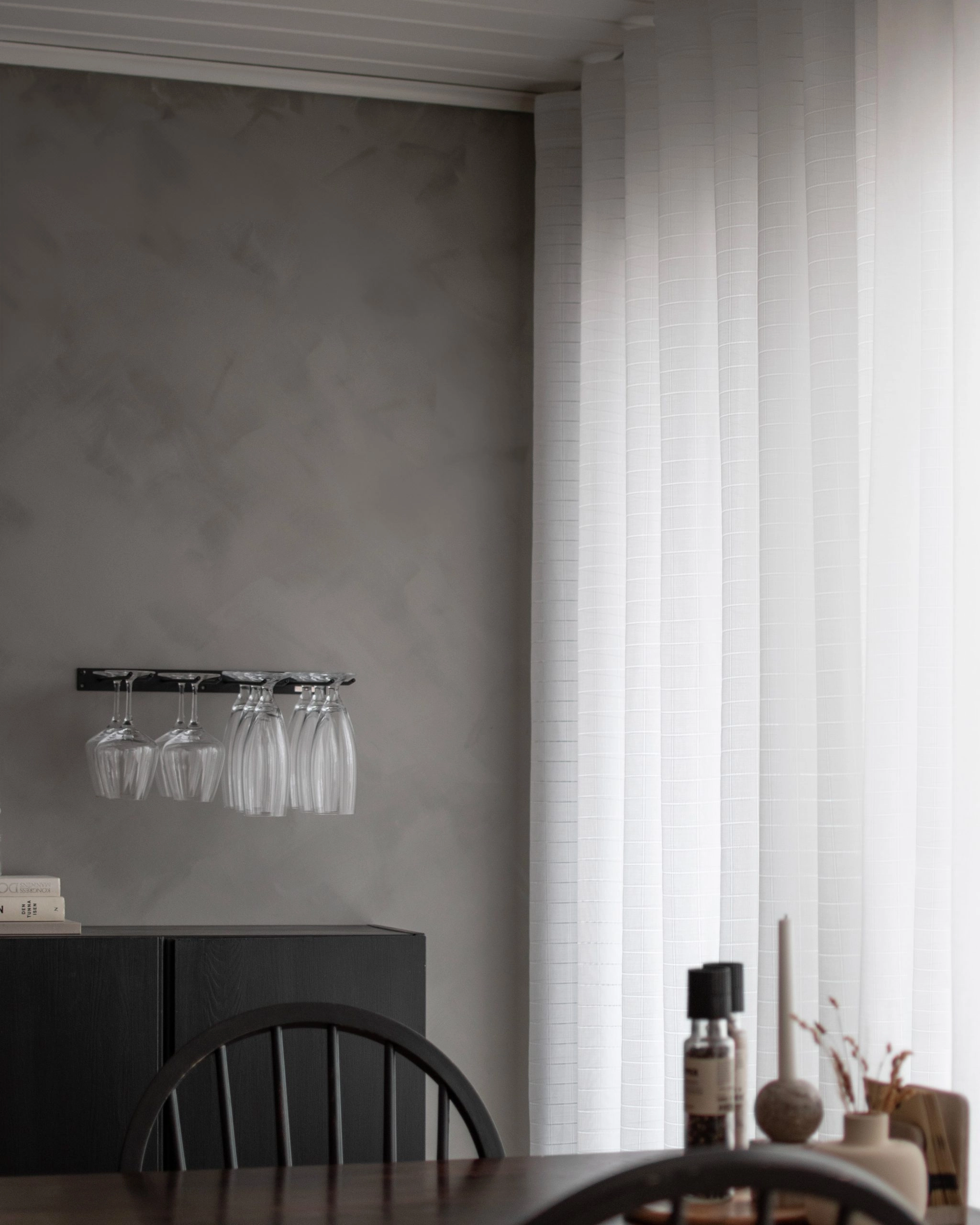 Made-to-measure Minna curtain with a die-cut check pattern in the dining room.